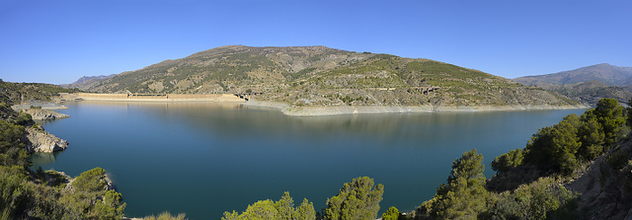 Low water at Presa de Rules dam, Spain. The Embalse de Rules  also called Dam of Rules , showing low water level in May 2023. Normally the levels could be expected to reach the lower levels of the 8 apertures visible on the left of the image. Embalse de Rules is located in the riverbed of Guadalfeo in Andalucia, downstream of its confluence with the River Izbor in the towns of Velez de Benaudalla and Orgiva. The water is coming from the southern slopes of the Sierra Nevada, the northern massif of Sierra de Lujar and the mountains of Contaviesa., by DAVID PARKER SCIENCE PHOTO LIBRARY