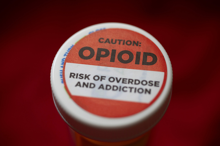 Prescription drug bottle Prescription drug bottle, with a label warning about the danger of opioid addiction and overdose., by JIM WEST SCIENCE PHOTO LIBRARY
