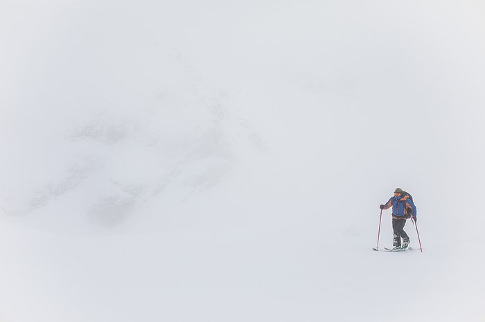 Man ski touring in white out conditions, poor visibility, by Cavan Images / Christopher Kimmel / Alpine Edge Photography