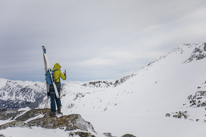 Skier takes photo from mountain summit, by Cavan Images / Christopher Kimmel / Alpine Edge Photography