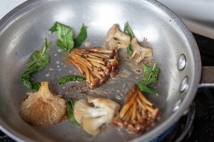 Foraged wild mushrooms saut茅 in a skillet, by Cavan Images / Mark Lipczynski