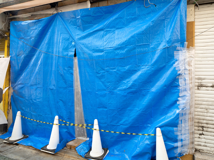 Construction site covered with blue sheets