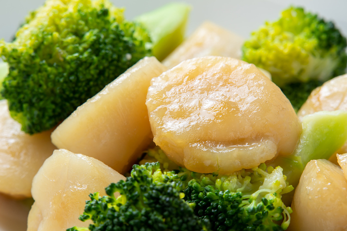 Close-up of stir-fried scallops and broccoli.