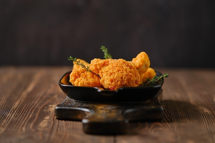 Photo with shallow depth of field of deep fried spicy chicken meat closeup, by Aleksei Isachenko