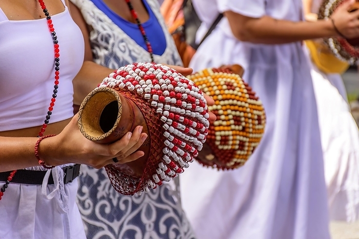 Woman playing a type of rattle called xereque of African origin used in the streets of Brazil during samba performances at traditional carnival festivities, Brasil, by Fred Pinheiro