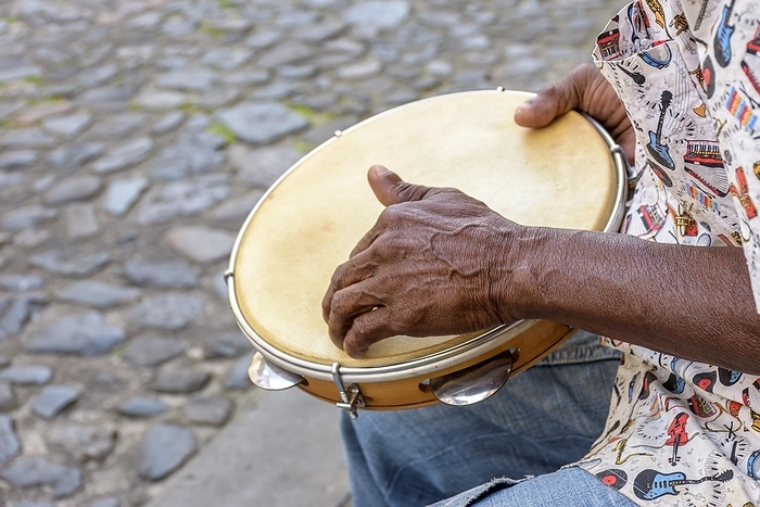 Brazilian samba performance with musician playing tambourine in the streets of Pelourinho, city of Salvador, Bahia, Brasil, by Fred Pinheiro