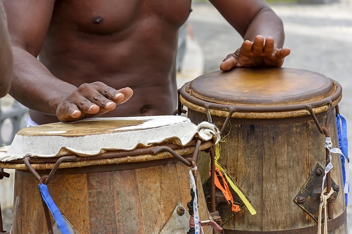 Musician playing atabaque which is a percussion instrument of African origin used in samba, capoeira, umbanda, candomble and various cultural, artistic and religious manifestations in Brazil, Brasil, by Fred Pinheiro