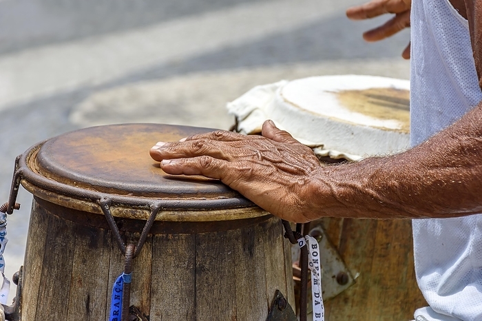 Musician playing a traditional Brazilian percussion instrument called atabaque during a capoeira performance on the streets of Pelourinho in Salvador, Bahia, Brasil, by Fred Pinheiro