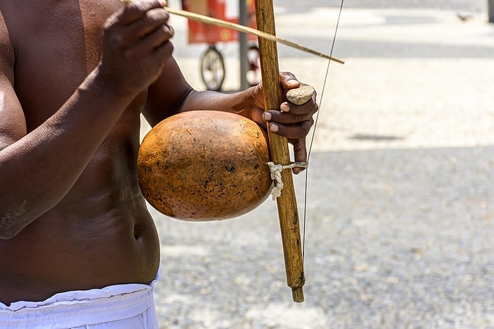 Musicians playing traditional instruments used in capoeira, a mix of fight and dance from Afro-Brazilian culture in the streets of Pelourinho in Salvador, Bahia, Brasil, by Fred Pinheiro