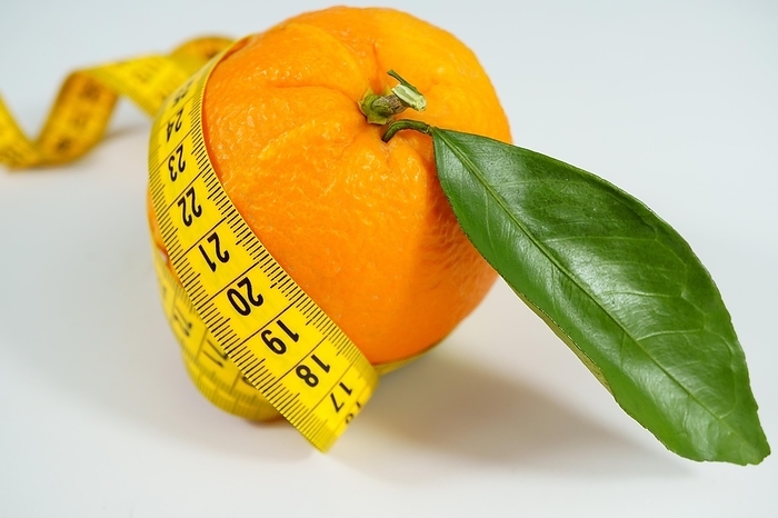 Fresh orange with leaves surrounded by a tape measure isolated on white background and copy space, by jose hernandez antona