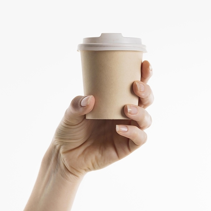 Hand holding coffee cup, by Oleksandr Latkun