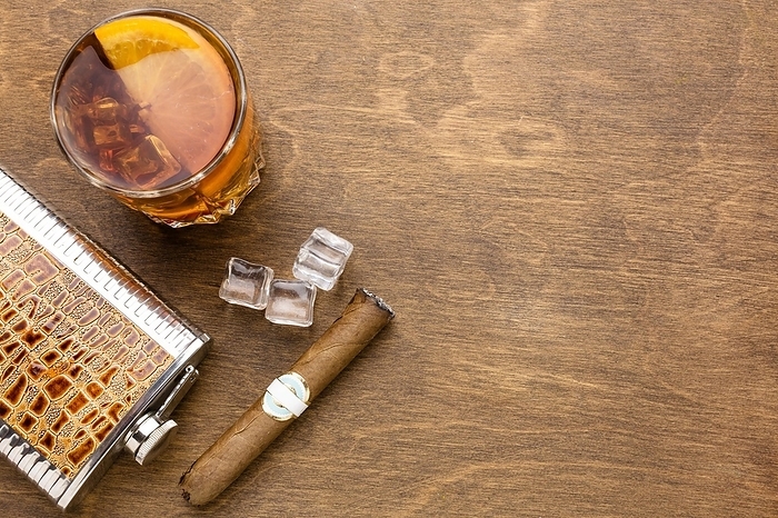 Top view whiskey with orange cigar with copy space. Beautiful photo, by Oleksandr Latkun