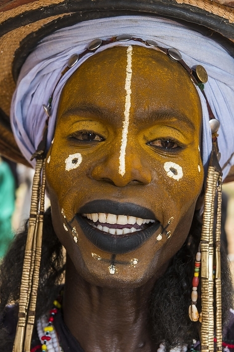 Wodaabe-Bororo man with faces painted at the annual Gerewol festival, courtship ritual competition among the Fulani ethnic group, Niger, Africa, by Michael Runkel