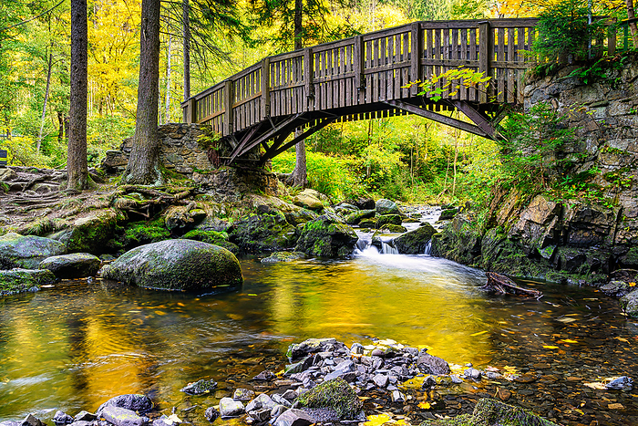 Wooden bridge over the Oker river with large stones on Engagement island in the Harz Mountains, Wooden bridge over the Oker river with large stones on Engagement island in the Harz Mountains,, by Zoonar Andreas V lk