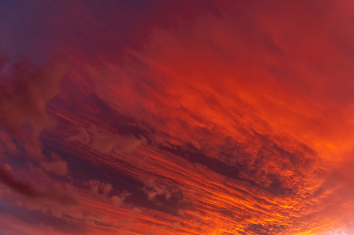 Huge orange cloud in the sky at sunset. Huge orange cloud in the sky at sunset., by Zoonar Christian Dec