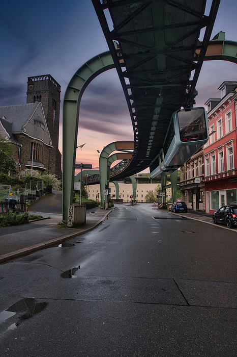 Low angle shot of a suspension railroad over Wuppertal s street in Germany Low angle shot of a suspension railroad over Wuppertal s street in Germany, by Zoonar Raffael Herrm