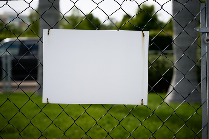blank white unlabeled sign with text space on a fence blank white unlabeled sign with text space on a fence, by Zoonar Heiko Kueverl