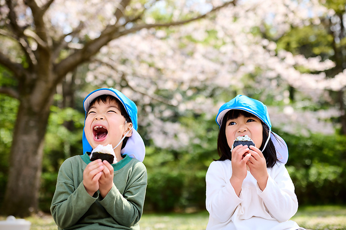 Japanese child eating an onigiri