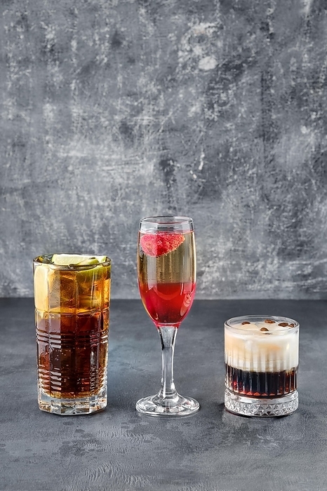 Party cocktails, cuba libre, whiskey sour and a sparkling wine with strawberry