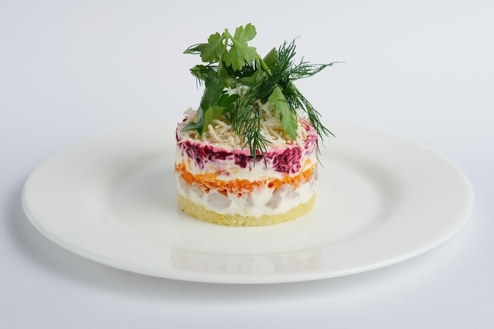 Traditional russian salad herring with beetroot, potato, carrot, eggs, cheese and mayonnaise