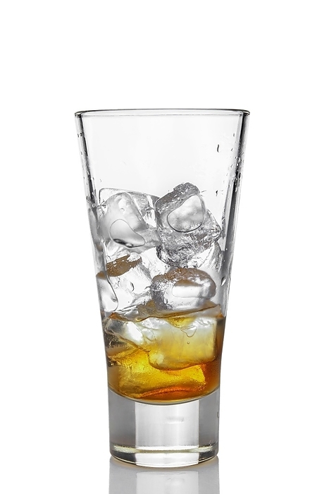 Highball glass with ice and whiskey isolated on white