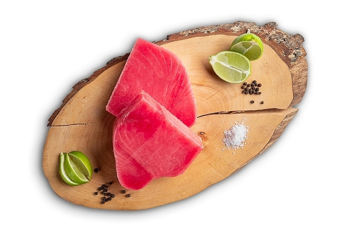 Fresh raw tuna steak on wooden cutting board, top view isolated on white