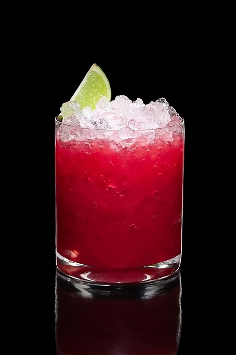 Cold strawberry cocktail with ice crush and lime