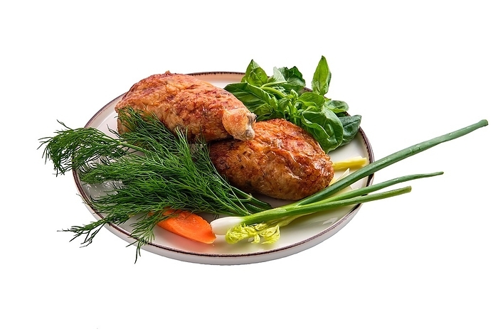 Stuffed chicken thigh decorated with spring onion, carrot, basil and dill on white background