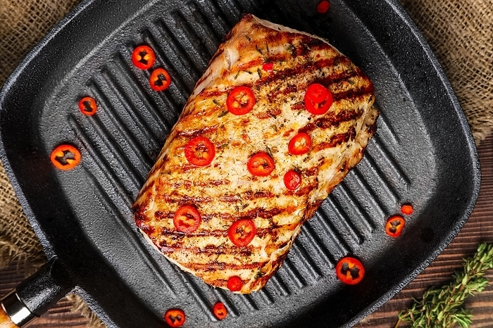 Close up view of grilled meat on cast-iron pan