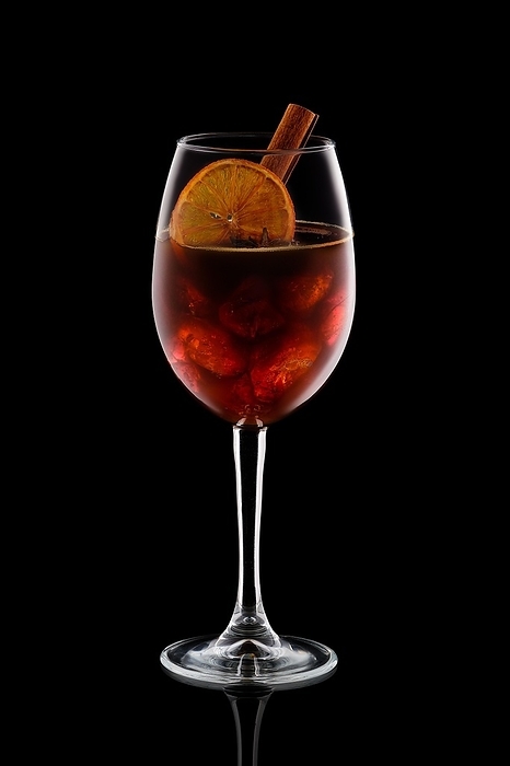 Cold alcoholic cocktail with cognac, coffee and ice isolated on black background