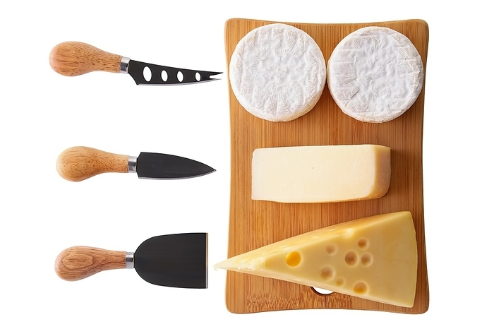 Different types of cheeses, brie, camembert, parmesan and gouda on wooden board with cheese knives isolated on white background
