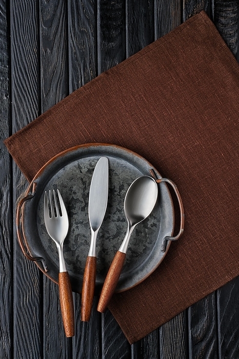 Stylish cutlery set of knife, spoon, fork with wooden handle