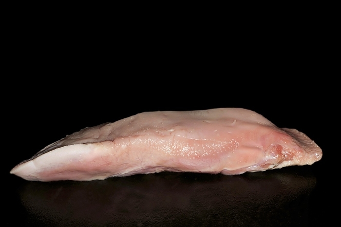 Cured raw pork tongue, food photography with black background
