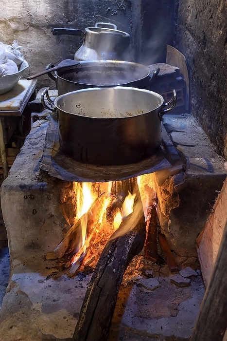 Traditional Brazilian food being prepared on old, dirty and popular wood stove, Brasil