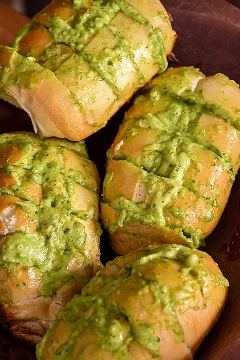 Garlic bread appetizer with melted cheese and fine aromatic herbs roasted on the barbecue grill, Brasil
