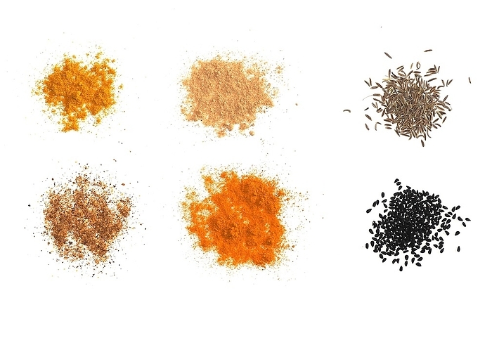 Many spices including Ginger Curry Turmeric Chili pepper Black cumin (Nigella sativa) over white