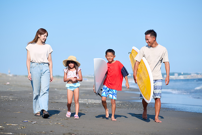 Japanese family walking on the beach
