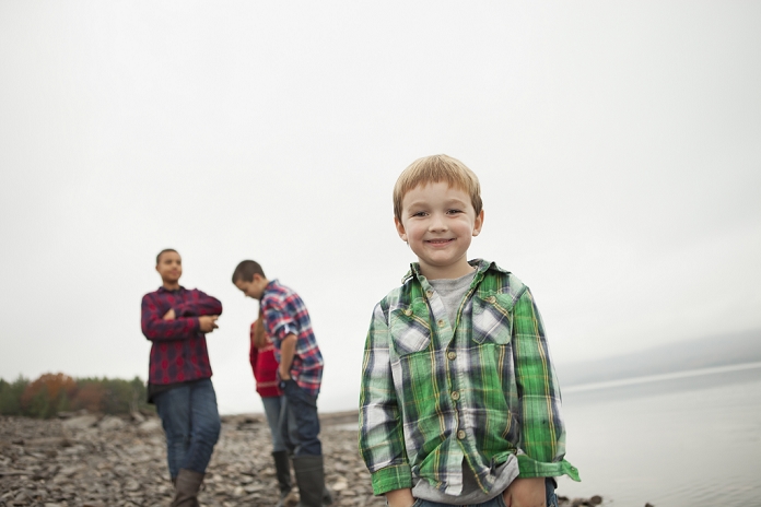 A day out at Ashokan lake. Three teenagers and a young boy on shore.