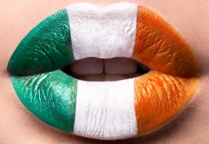 Female lips close up with a picture flag of Ireland. Green, white, Orange
