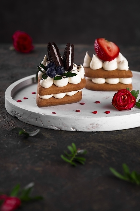 Sponge cakes, a heart-shaped cakes with cream and fruit. Dessert on Valentine's Day