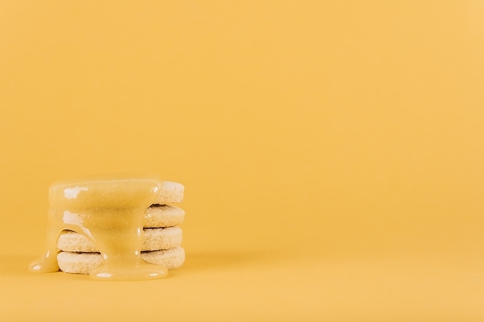 Stacked cookies with lemon curd yellow background
