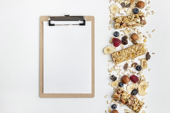 Top view breakfast cereal bars with fruits notepad