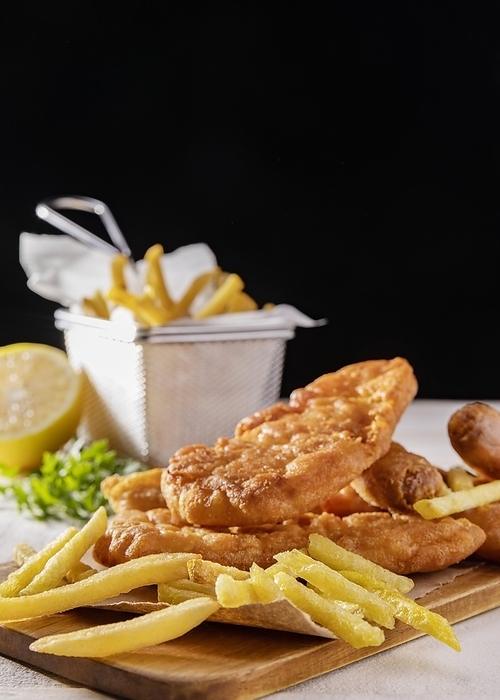 Fish chips chopping board with lemon copy space