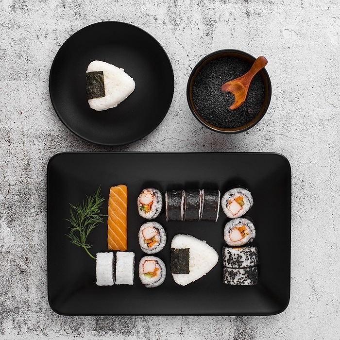 Flat lay assortment sushi black rectangular plate with copy space