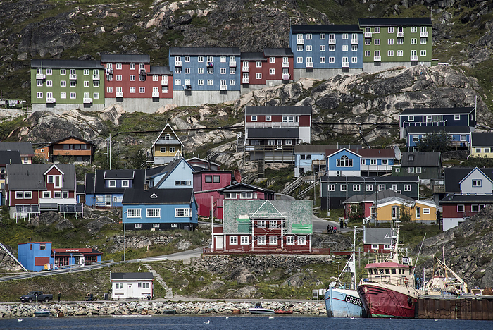 Close-up view of the colorful buildings on the rocky cliffs along the shore in the seaport town of Qaqortoq on Greenland's southern tip; Qaqortoq, Southern Greenland, Greenland, by Karen Kasmauski / Design Pics