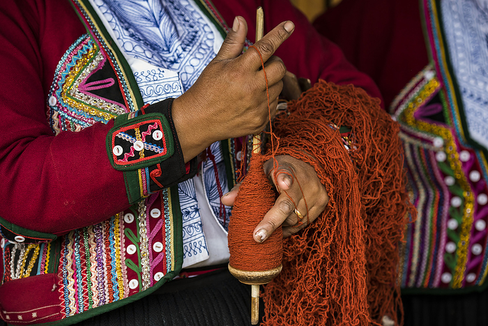 Quechuan women of Chinchero weave traditional clothes in traditional ways for sale; Cusco, Peru, by Michael Melford / Design Pics