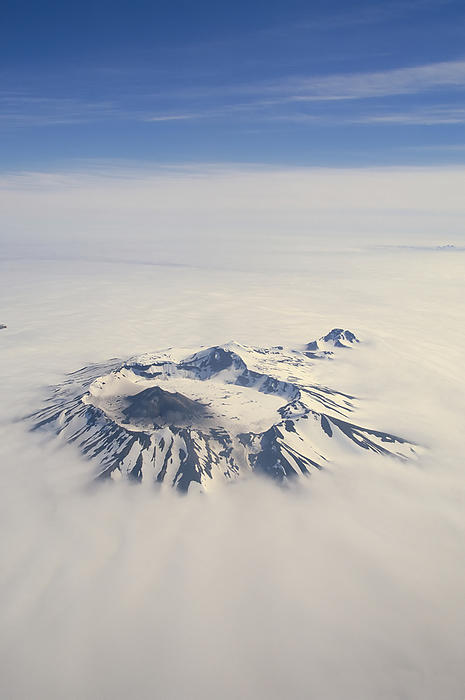 Clouds cover mountains over Unimak Island, Aleutian Islands, Alaska, USA; Unimak Island, Aleutian Islands, Alaska, United States of America, by Michael Melford / Design Pics