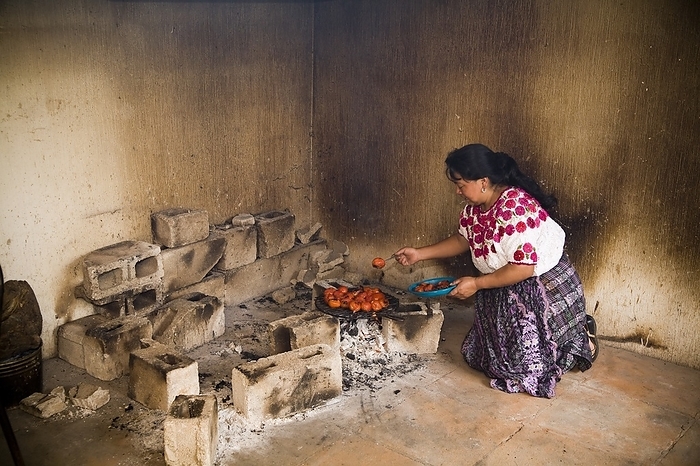 Guatemala Woman Cooking Over A Makeshift Barbecue  Patzicia,Guatemala, by Gregory Byerline   Design Pics