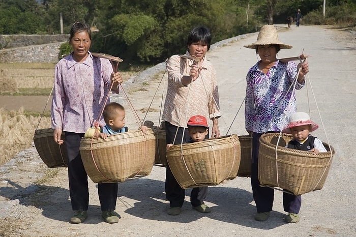 Three People Carrying Baskets With One Child In Each, by Keith Levit / Design Pics
