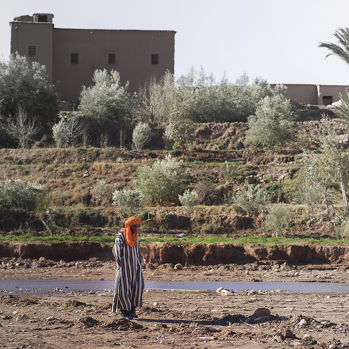 Morocco Ait Ben Haddou A Man Walks Alone Over A Dirt Field With A Building In The Background  Ait Benhaddou, Souss Massa Dras, Morocco, by Keith Levit   Design Pics